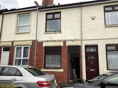 Pair of cream-painted terraces with cars parked at the kerb